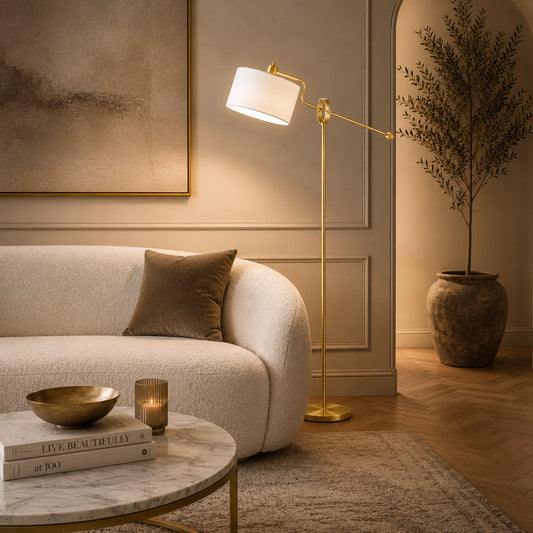 Modern designer floor lamp featuring a brass frame and white drum shade