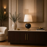 Designer table lamp with spherical black base and white tapered shade